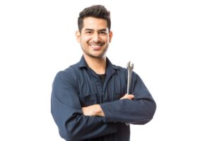 mechanic with wrench standing hands folded on white background